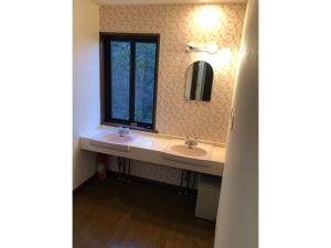 a bathroom with two sinks and a window at Trust Maison Katase - Vacation STAY 24205v in Izu