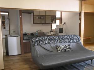 a large couch in a room with a kitchen at Trust Maison Hokkawa - Vacation STAY 24203v in Okawa