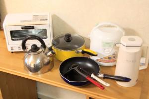 a counter top with a tea pot and a toaster at Monthly Mansion Tokyo West 21 - Vacation STAY 10868 in Fuchu