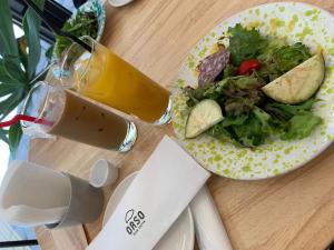 a plate of food with a salad and a drink at Alaula - Vacation STAY 22838v in Izumi-Sano