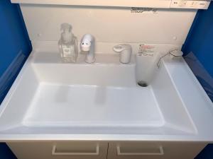 a white sink with a bottle of soap on it at Alaula - Vacation STAY 22838v in Izumi-Sano +69 photos