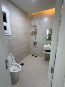 a bathroom with a toilet and a sink at new Salalah apartment in Salalah