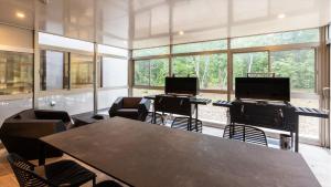 a conference room with two laptops on tables and chairs at Ferri Endolph - Vacation STAY 50192v in Naka-satsunai