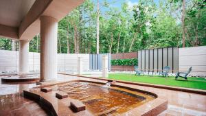 a patio with a fountain in the middle of a yard at Ferri Endolph - Vacation STAY 50192v in Naka-satsunai