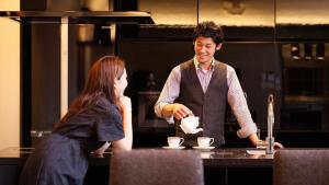 a man pouring a woman a cup of coffee at Ferri Endolph - Vacation STAY 50192v in Naka-satsunai +15 photos