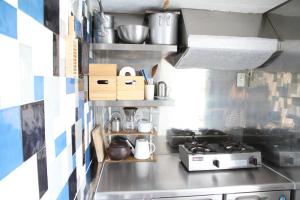 a small kitchen with a stove and some pots and pans at Izu Cliff House - Vacation STAY 29217v in Ihama
