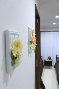 two pictures of flowers hanging on a wall at Wonderful stay TOKYO - Vacation STAY 30862v in Tokyo