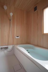 a bath tub in a bathroom with a window at Nikko, Matsubara no Yado - Vacation STAY 31914v in Nikko