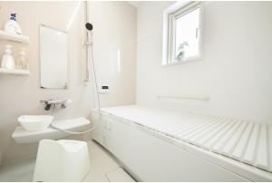 a white bathroom with a toilet and a window at Nasushiobara Renga no ie SORA - Vacation STAY 10890 in Nasushiobara +25 photos