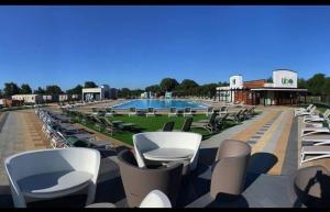 a row of chairs and a swimming pool at Larch View in Tattershall +13 photos