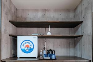 a refrigerator sitting on a shelf in a kitchen at STEP by STEP - Vacation STAY 25751v in Kanayama