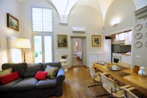 a living room with a couch and a table at Acacia Firenze Apartments Artemisia-Angelica in Florence