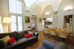 a living room with a couch and a table at Acacia Firenze Apartments Artemisia-Angelica in Florence