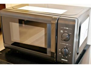 a microwave oven sitting on top of a counter at Ocean Terrace Sesoko 101 - Vacation STAY 28609v in Ufugumui