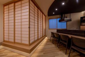 a room with a bar with a row of chairs at Oyado Kai - Vacation STAY 35285v in Sasebo