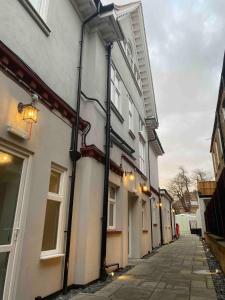 a building with black pipes on the side of it at Dream Yard Apartments Westcliff in Southend-on-Sea