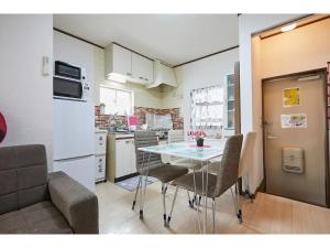 a kitchen and dining room with a table and chairs at La Mer Urayasu - Vacation STAY 11148 in Urayasu