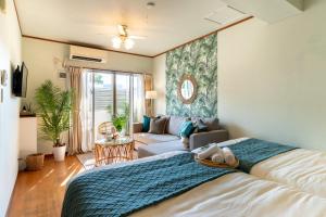 a bedroom with a bed and a living room at ISHIGAKI HOUSE - Vacation STAY 55890v in Ishigaki Island