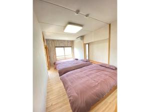 a room with four beds in it with a window at Trust Maison Ito Hagi - Vacation STAY 32263v in Ito