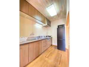 a kitchen with a sink and a refrigerator at Trust Maison Ito Hagi - Vacation STAY 32263v in Ito