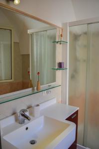 a bathroom with a sink and a mirror at Casa Camillo Querno in Monopoli