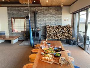 a table with food on it in a room with a fireplace at Seaside Villa SASAO - Vacation STAY 33407v in Sanuki