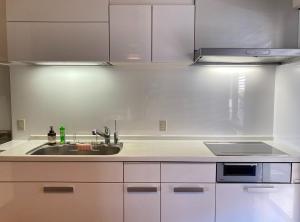 a kitchen with white cabinets and a sink at Seaside Villa SASAO - Vacation STAY 33407v in Sanuki +31 photos