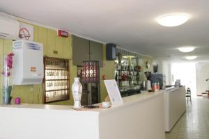 a kitchen with a counter and a bar in a room at Hotel Bacco in Rimini