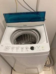 a washing machine with a blue box on top of it at A,T,HOTEL HAKATA - Vacation STAY 36414v in Fukuoka