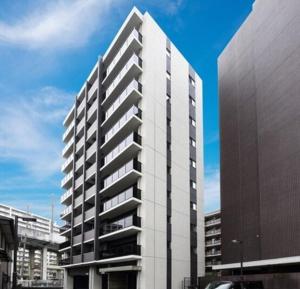 a tall white building in front of a building at A,T,HOTEL HAKATA - Vacation STAY 36414v in Fukuoka +15 photos