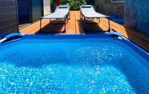 a swimming pool with two chairs and a pool at Sani no Teitaku - Vacation STAY 36110v in Amami