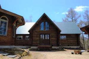 a wooden house with a large window and a roof at Chamonix - Vacation STAY 67793v in Iiyama