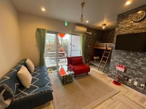 a living room with a couch and a tv at Hotel Yua - Vacation STAY 40741v in Nago +22 photos