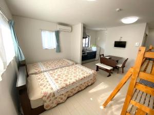 a bedroom with a bed and a desk in it at Watatsumi no yado - Vacation STAY 44120v in Iki