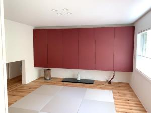 a living room with red cabinets and a table at Guest House Paper Moon - Vacation STAY 45012v in Yamanakako