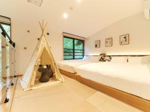 a bedroom with two beds and a teepee tent at Rakuten STAY VILLA Hakone Sengokuhara South Wing 104 or 105 BBQ Terrace Pet allowed Capacity of 10 persons in Hakone