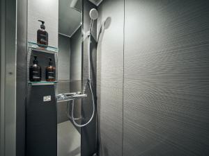 a bathroom with a shower with two bottles on the wall at Rakuten STAY VILLA Hakone Sengokuhara South Wing 104 or 105 BBQ Terrace Pet allowed Capacity of 10 persons in Hakone +43 photos
