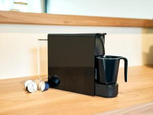 a black coffee maker sitting on a counter at Rakuten STAY VILLA Hakone Sengokuhara South Wing 104 or 105 BBQ Terrace Pet allowed Capacity of 10 persons in Hakone