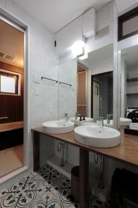a bathroom with two sinks and a large mirror at ROYAL SUITE SAKAE - Vacation STAY 11483 in Nagoya