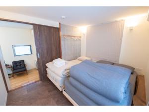 a small room with a bed and a chair at bmj Hyakunincho - Vacation STAY 46879v in Tokyo