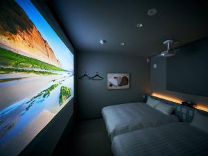 a bedroom with a bed and a large tv at Rakuten STAY VILLA Hakone Sengokuhara North Wing 101 or 103 BBQ terrace Capacity of 10 persons in Hakone