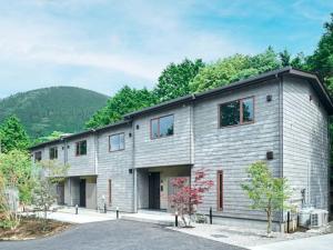 a large gray building with a lot of windows at Rakuten STAY VILLA Hakone Sengokuhara North Wing 101 or 103 BBQ terrace Capacity of 10 persons in Hakone