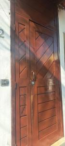a wooden door with wooden panels on a wall at Appartamento mobiliado in Natal