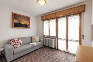 a living room with a couch and a window at Dolomitohouse PEZ in Fiera di Primiero