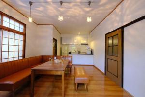 a dining room with a table and a couch at iORi Yufuin - Vacation STAY 42351v in Yufuin