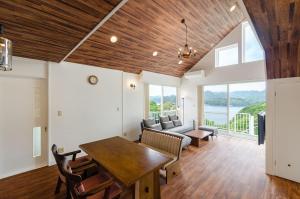 a living room with a table and chairs and a couch at Bay Coast Villa Susaki - Vacation STAY 45723v in Shimoda