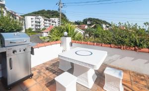 a barbecue on the roof of a house at Bay Coast Villa Kisami - Vacation STAY 33529v in Shimoda