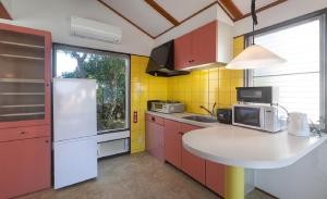 a kitchen with a counter with a microwave and a refrigerator at Bay Coast Villa Kisami - Vacation STAY 33529v in Shimoda