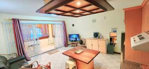 a living room with a couch and a table at Richmond Hill Apartment, Grand-Bay in Grand Baie
