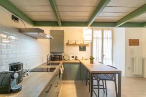 a kitchen with a wooden counter top and a table at Modern apartment with parking, Wi-Fi & SmartTv in Como